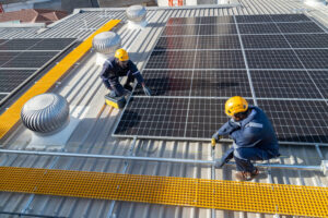 Engineers and technicians check drawings for installing solar cell panels on the roof. alternative energy energy from the sun